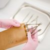 cosmetologist-in-gloves-holds-manicure-equipment-RJC3VBT.jpg